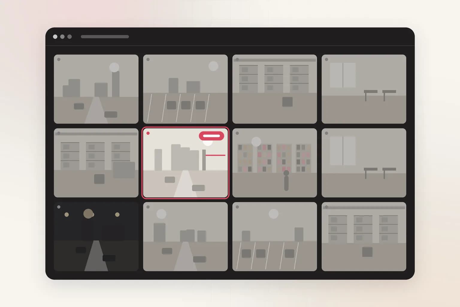 A dark video management wall of 12 camera feeds, with a coral alert badge on one camera.
